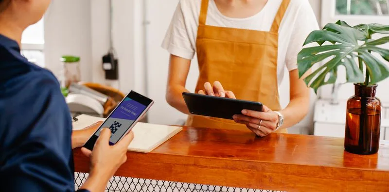 A customer paying with a QR code on their phone